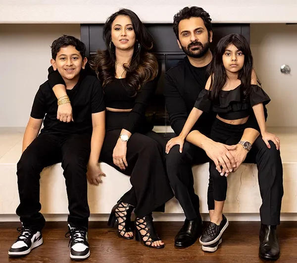 Divine Teams founders and family in professional black attire, representing the leadership behind the brand