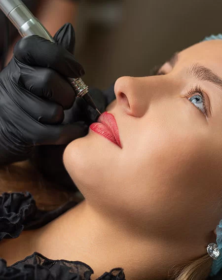 Professional permanent makeup lip blush tattoo procedure for defined, tinted lips at Divine Threading Las Vegas salon.